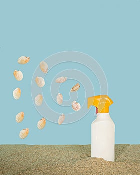 spraying shells on a sandy beach with blue background.summer sunny concept idea