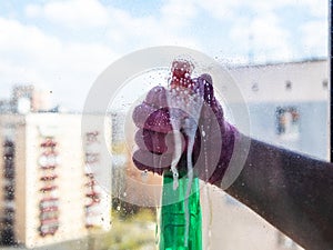 spraying of washing liquid on surface of window