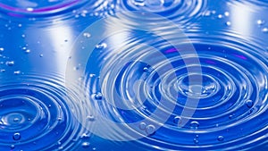 Spread across a vibrant blue water surface creating a pattern of circular