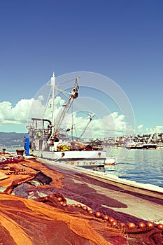 Spread fishing nets, fishing boat on dock