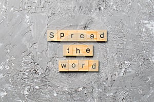 Spread the word word written on wood block. Spread the word text on table, concept photo