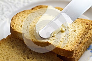 Spreading butter on bread