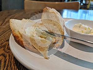 Spreading butter on bread with a knife.