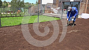 Spreading grass seeds in spring by hand for the perfect lawn. Static shot