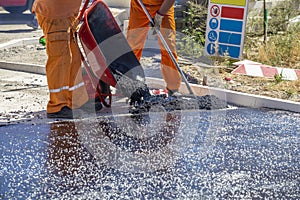 Spreading hot asphalt, new asphalt laying work