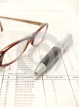 Spreadsheet, pen and eyeglasses