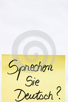 Sprechen sie deutsch  do you speak german handwriting text close up isolated on yellow paper with copy space