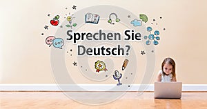 Sprechen Sie Deutsch text with little girl using a laptop computer