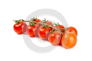 Sprig of cherry tomatoes isolated on white background.