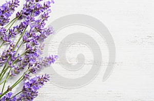 Sprigs of lavender on wooden shabby background