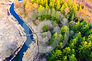 Spring aerial landscape. Dry season in forest near river curve. Cold season concept