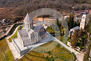 Spring aerial view of Bodbe monastic complex on hillside, Georgia