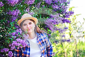 Spring allergy. Defocus beautiful young woman near blooming spring tree. Bush lilac flowers. Youth, love, fashion