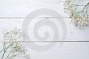 Spring background, flowers frame on blue wooden table. Banner mockup for Womans or Mothers Day, Easter, spring holidays. Flat lay,