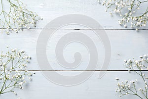 Spring background, flowers frame on blue wooden table. Banner mockup for Womans or Mothers Day, Easter, spring holidays. Flat lay,