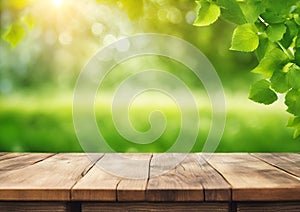 Spring background with green foliage and empty wooden table in nature. Beauty bokeh and sunlight.