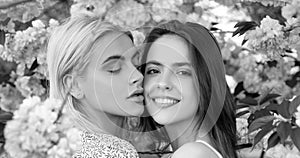 Spring banner with women girlfriends outdoor. Spring girls. Lesbian couple kissing. Beautiful spring sexy young woman