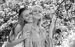 Spring banner with women girlfriends outdoor. Two young women relaxing in sakura flowers. Spring girls.