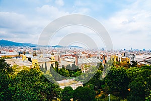 Spring Barcelona general view on a cloudy day from mountain Montjuic. Clouds, beautiful landscape, urban streets, roofs, blooming