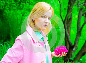 Spring. Beautiful woman with peony flower. Romantic girl with Blooming Peonies flowers.