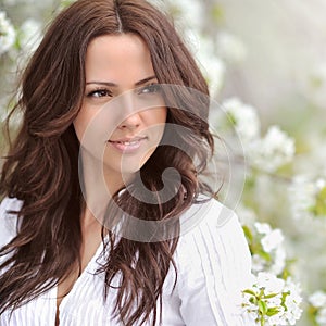 Spring beauty girl. Beautiful young woman in a summer park outdo