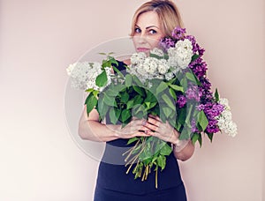 Spring bouquet of lilacs in woman hands. Woman portrait .