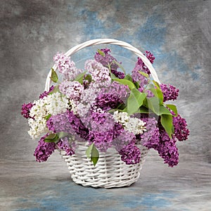 Spring bouquet. Lily of the valley and lilac in a basket