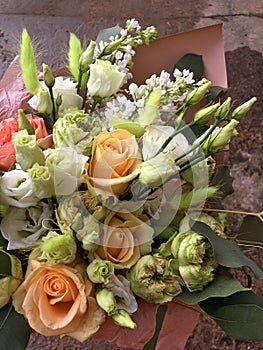 Spring bouquet of mixed colorful flowers. Flowers bouquet including white lilac, white Eustoma, orange rose. Beautiful bright