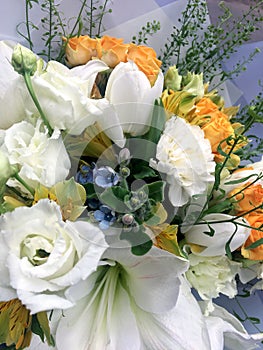Spring bouquet of mixed colorful flowers. Flowers bouquet including white tulips, white amarilis, yellow roses blue oxypetalum,