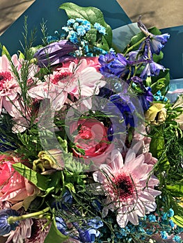 Spring bouquet of mixed colorful flowers. Flowers bouquet including pink chrysanthemum, Beautiful Blue Delphinium, pink rose.