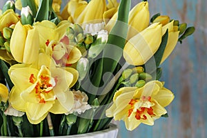 Spring bouquet with yellow tulips, carnations and daffodils