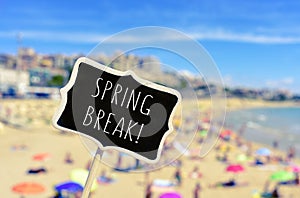 Spring break in a black signboard on the beach