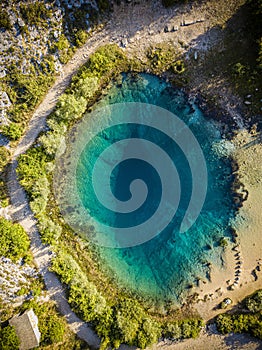 The spring of the Cetina River, izvor Cetine, in the foothills of the Dinara Mountain is named Blue Eye, Modro oko. Cristal clear