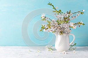 Spring cherry blossom flowers on blue wooden background with copy space. still life. womens day concept