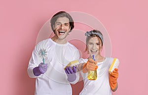 Spring Cleaning. Cheerful Millennnial Couple Posing With Household Tools In Hands