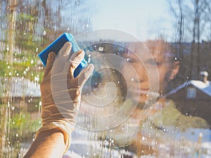 Spring cleaning - cleaning windows. Women`s hands wash the window, cleaning