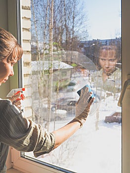 Spring cleaning - cleaning windows. Women`s hands wash the window, cleaning