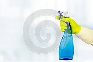 Spring cleaning concept. Hand Holding Spray Bottle. Woman holding bottle of detergent on white background. General or regular