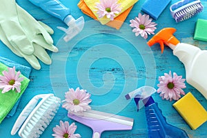 Spring cleaning concept with supplies over blue wooden background. Top view, flat lay