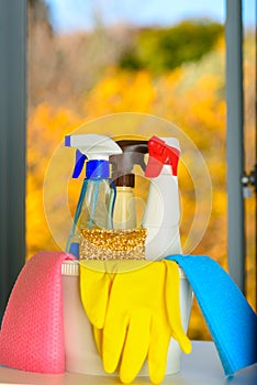Spring cleaning concept with supplies over floral background.