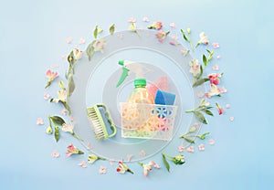 Spring cleaning concept with supplies over pastel blue background. Top view, flat lay