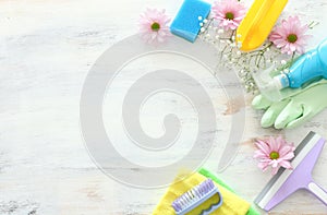 Spring cleaning concept with supplies over white wooden background. Top view, flat lay