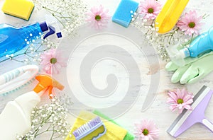 Spring cleaning concept with supplies over white wooden background. Top view, flat lay