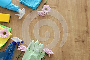 Spring cleaning concept with supplies over wooden background. Top view, flat lay