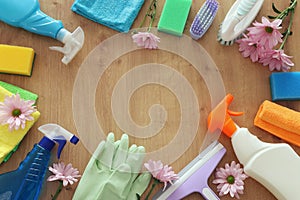 Spring cleaning concept with supplies over wooden background. Top view, flat lay