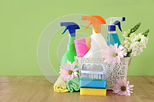 Spring cleaning concept with supplies on wooden table