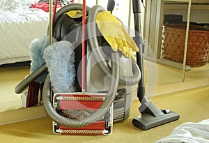 Spring-cleaning or house-cleaning concept wth vaccuum cleaner,carpet sweeper,feather duster and rubber gloves