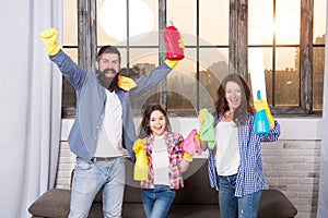 Spring cleaning. Your one stop for home cleaning needs. Happy family hold cleaning products. Mother, father and daughter