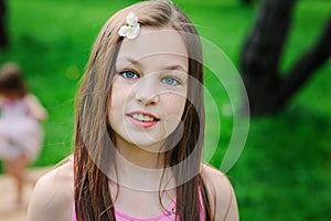 Spring closeup outdoor portrait of adorable 11 years old preteen kid girl