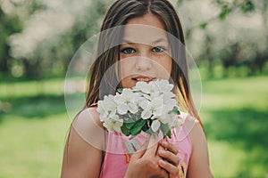 Spring closeup outdoor portrait of adorable 11 years old preteen kid girl